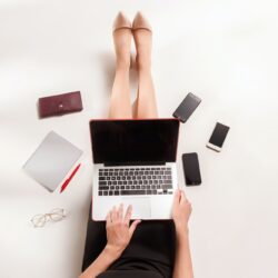 Fashion blogger writing on laptop computer