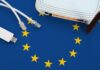 European union flag depicted on table with internet rj45 cable